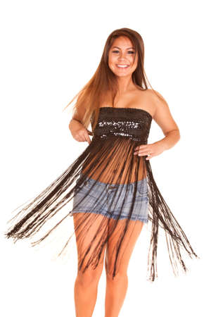 a woman with a smile on her face, twirling around and letting the fringe on her dress flow.の写真素材