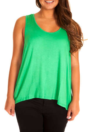 a woma with a smile on her face, wearing a green tank and pants.の写真素材