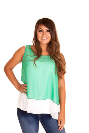A woman in her green and white tank wearing jeans.の写真素材