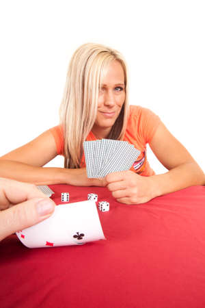 A person is looking at his cards with a woman in the background.の写真素材