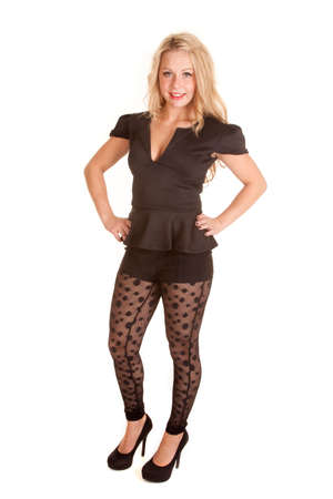 A woman with her hands on her hips, wearing her see through leggings and a black top.の写真素材