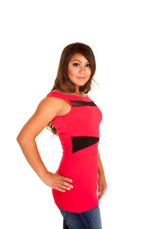 A woman in her red and black top with her hand on her hip.の写真素材