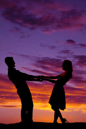 A man and woman dancing in the beautiful night sky.の写真素材