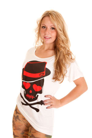 A woman with her hands on her hips in her skull t-shirt.の写真素材