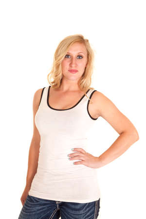 A woman in a white tank and jeans, with her hand on her hipの写真素材