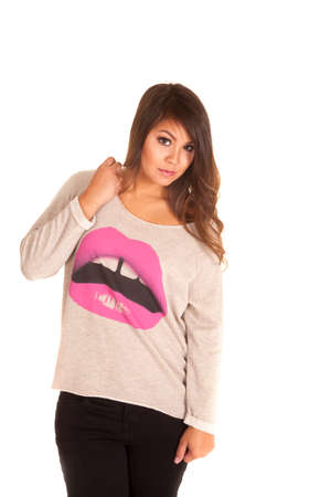 A woman in a loose fitting sweater with a serious expression on her face.の写真素材