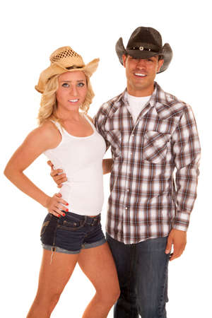 a cowgirl and cowboy with smiles they are holding on to each other.の写真素材