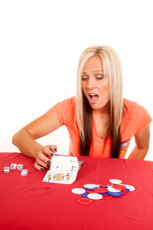 A woman showing a trick, by flipping cards over.の写真素材