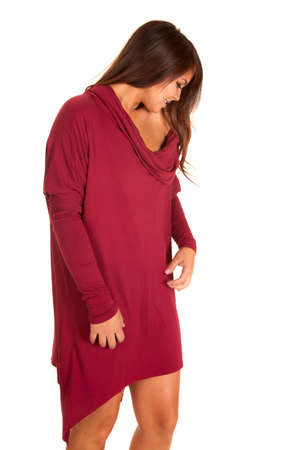 A woman in her maroon sweater dress looking down.の写真素材