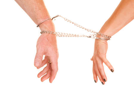 A man and woman's arms locked up together with their hands down.の写真素材