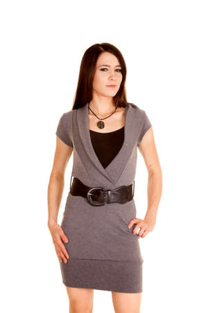 A woman in her gray sweater dress with a serious expression on her face.の写真素材