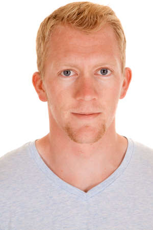A man in his shirt looking at the camera with a serious expression on his face.の写真素材