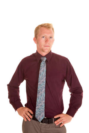 A man in his dress shirt and tie with his hands on his hips.の写真素材