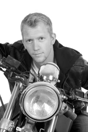 A man leaning forward over the handle bars on his bike.の写真素材