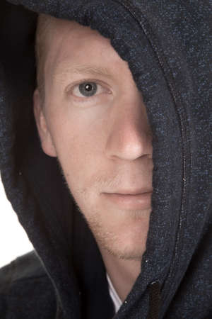 A close up of a man's face looking with half of his face hidden.の写真素材