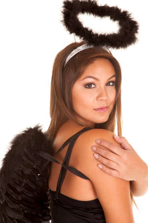 A close up of a woman in her black angel costume with wings and a halo.の写真素材