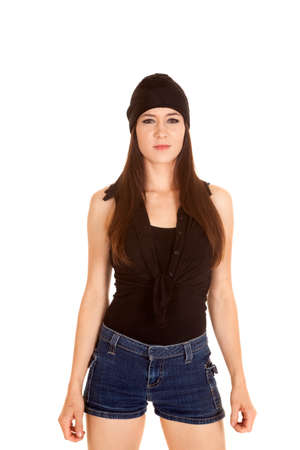 A woman in her black bandana and short shorts with a serious expression.の写真素材