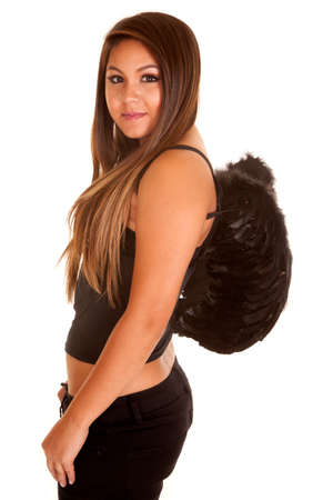 A woman in her costume with a pair of black wings on her back.の写真素材