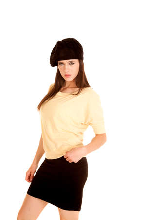 A woman in her yellow top with a black skirt and a french beret on her head.の写真素材