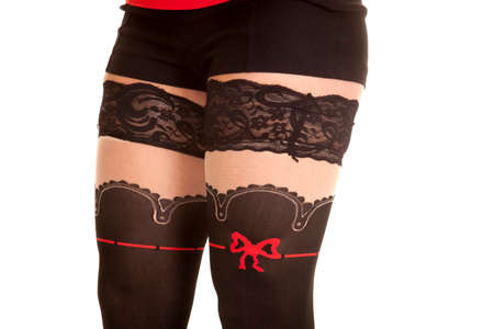 A close up of a woman's legs with tights on her legs.
