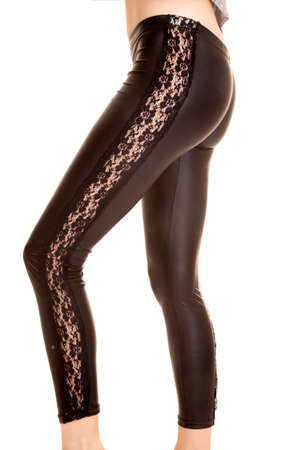 A woman in her leather lace leggings, standing sideways.の写真素材