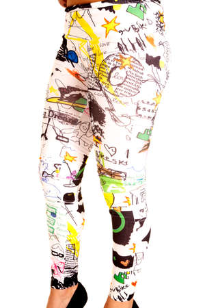 A woman in her white leggings with graffiti all over them.の写真素材
