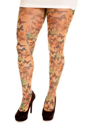 A woman standing in tights that look like leggings with butterflies on them.の写真素材