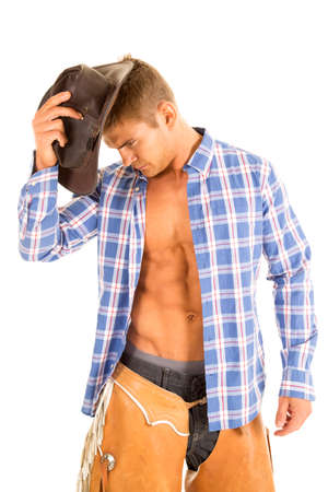A cowboy with his shirt unbuttoned and showing off his chest.の写真素材