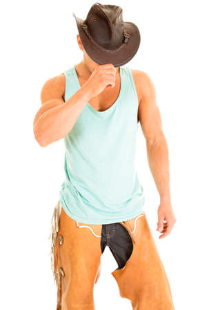 A cowboy pulling his hat down over his face.の写真素材