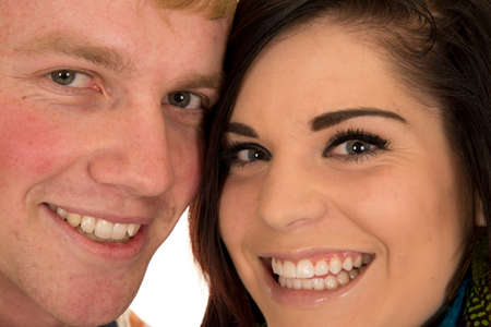 A man and woman with their heads together, with big smiles.の写真素材
