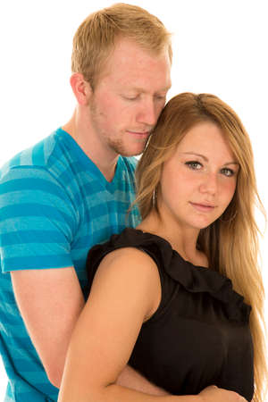 A man looking down at his woman holding on tight.の写真素材