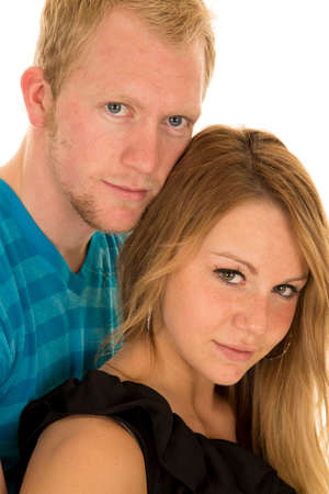 a couple holding on to each other with serious expressions.の写真素材