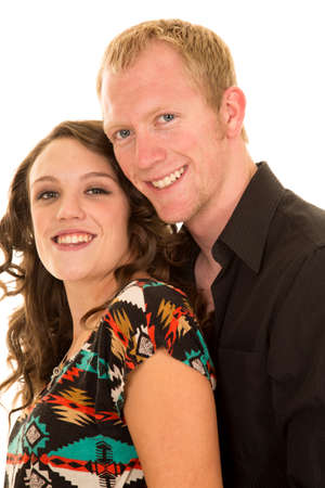 a man holding his girl close with smiles on their faces.の写真素材