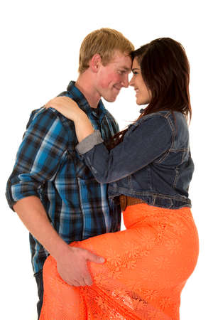 a man holding on to his woman's leg with their heads together.の写真素材