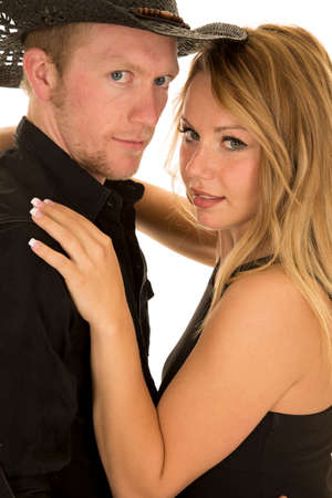 A cowboy cuddling with his woman looking at the camera.の写真素材