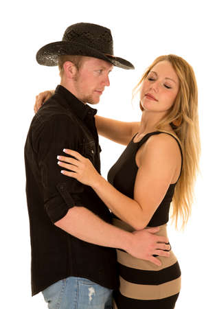 a cowboy looking at his woman while she has her eyes closed.の写真素材