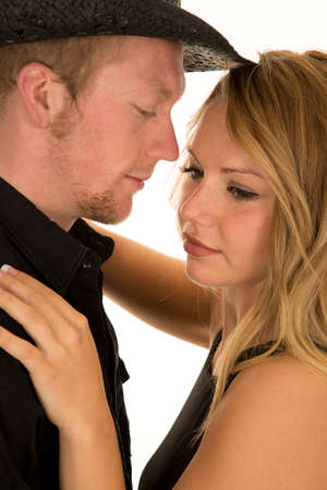 A close up of a woman with her cowboy, holding each other close.の写真素材