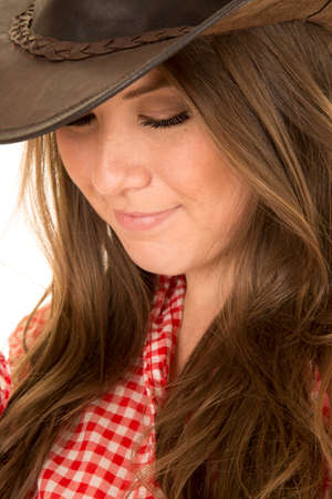 a close up of a cowgirl looking down.の写真素材