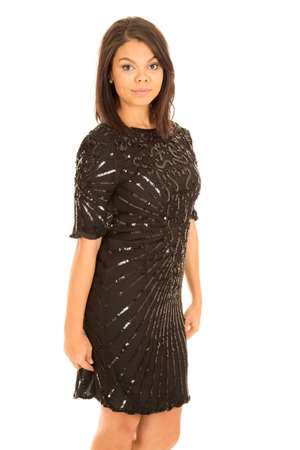A woman with her hands to her sides in her black formal dress.の写真素材