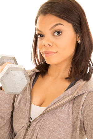 A woman in her fitness clothes working out with weights.の写真素材
