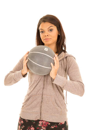 A woman working out with a medicine ball with a serious expression.の写真素材
