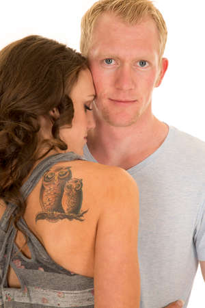A man looking with his woman cuddling close to him.の写真素材