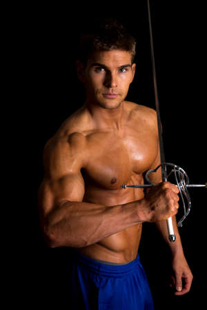 a man flexing his arms holding on to his sword.の写真素材