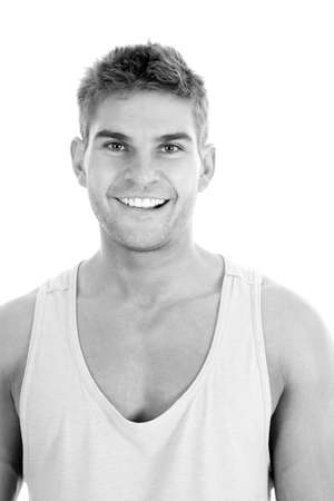 A black and white picture of a man in his tank with a big smile.の写真素材