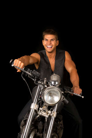 A man sitting on his motrocycle laughing.の写真素材