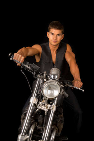 A man on his motorcycle with a serious expression.の写真素材