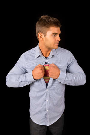 A man looking to the side, opening up his shirt.の写真素材