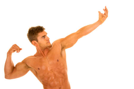 A man flexing his arms and body without a shirt on.の写真素材