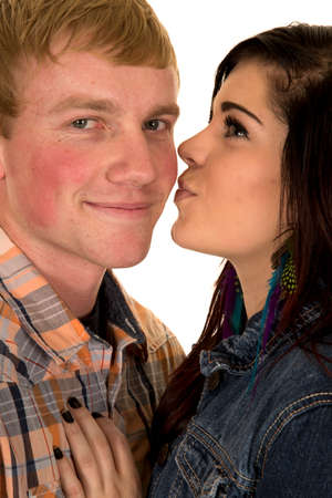 A woman getting ready to kiss her man on the cheek.の写真素材