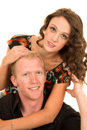 A man and woman close together. She is hugging him in her arms.の写真素材